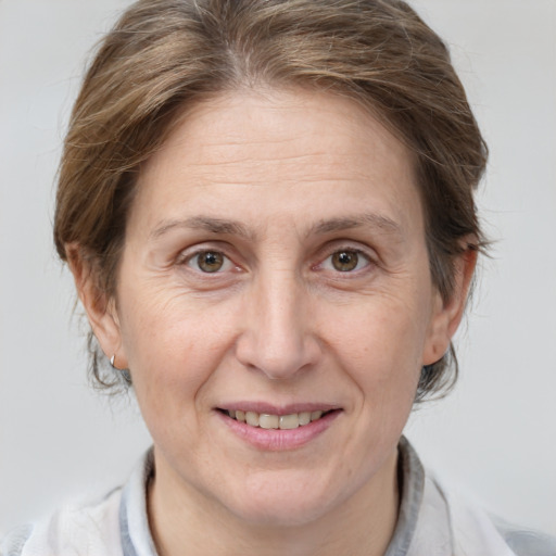 Joyful white adult female with medium  brown hair and brown eyes