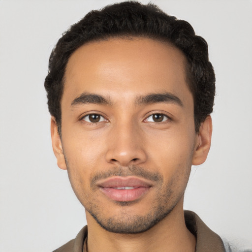 Joyful latino young-adult male with short  black hair and brown eyes