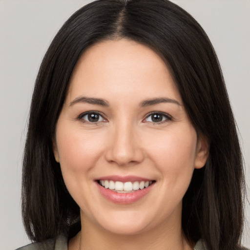 Joyful white young-adult female with long  brown hair and brown eyes