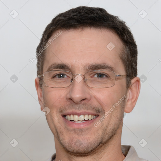 Joyful white adult male with short  brown hair and grey eyes