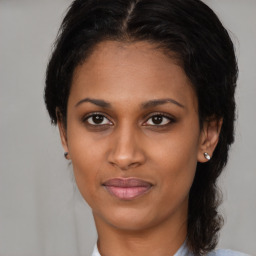 Joyful black young-adult female with medium  brown hair and brown eyes