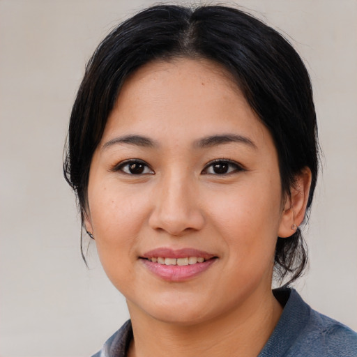 Joyful asian young-adult female with medium  brown hair and brown eyes