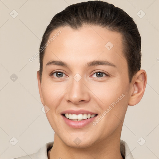 Joyful white young-adult female with short  brown hair and brown eyes