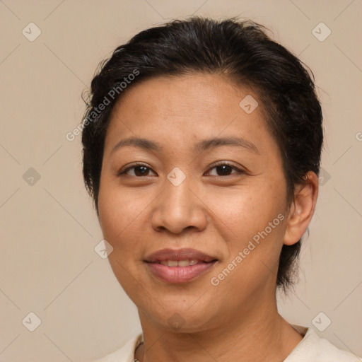 Joyful latino adult female with medium  brown hair and brown eyes