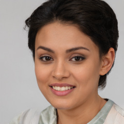 Joyful latino young-adult female with short  brown hair and brown eyes