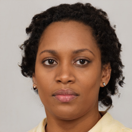 Neutral black young-adult female with medium  brown hair and brown eyes