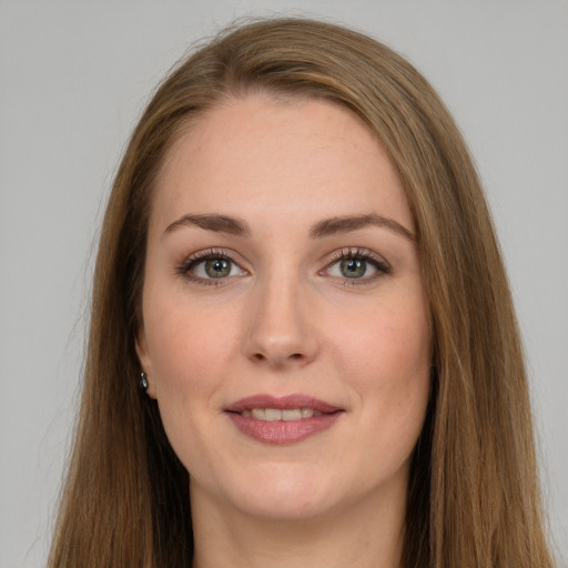 Joyful white young-adult female with long  brown hair and grey eyes