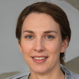 Joyful white adult female with medium  brown hair and grey eyes