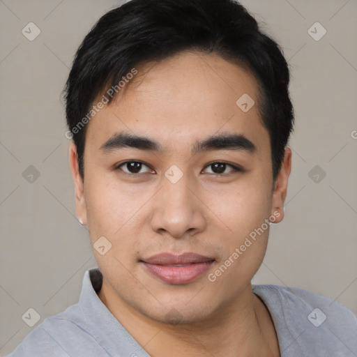 Joyful asian young-adult male with short  black hair and brown eyes