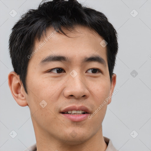 Joyful asian young-adult male with short  brown hair and brown eyes