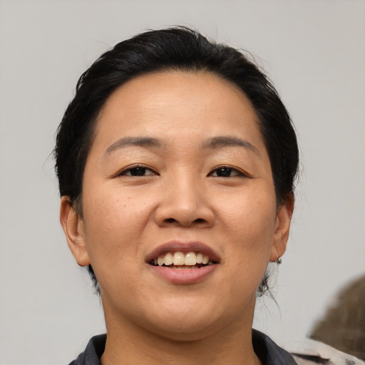 Joyful asian young-adult female with medium  brown hair and brown eyes