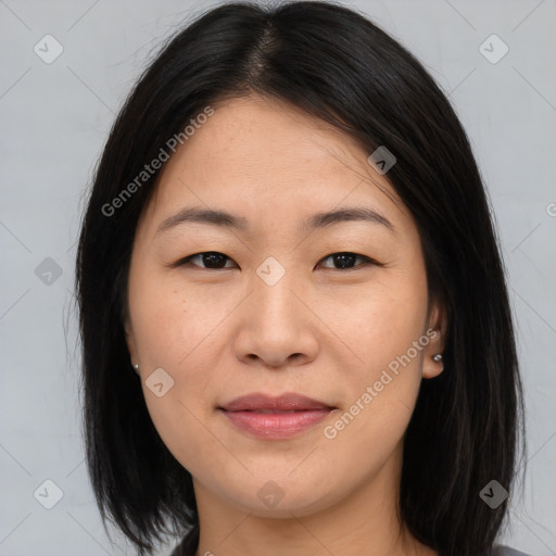 Joyful asian young-adult female with long  brown hair and brown eyes