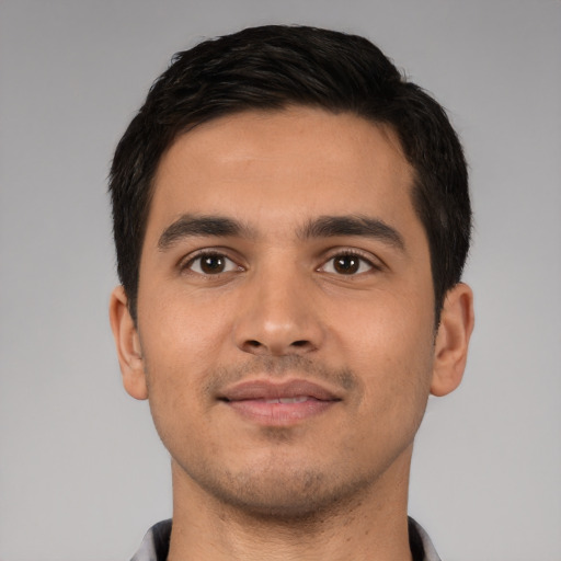 Joyful latino young-adult male with short  black hair and brown eyes
