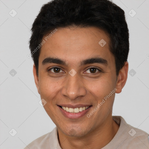 Joyful latino young-adult male with short  brown hair and brown eyes