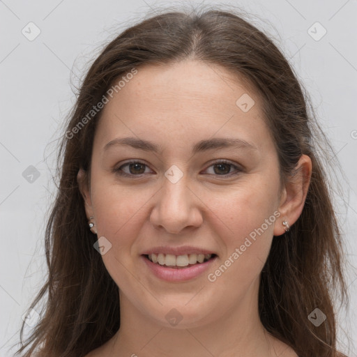 Joyful white young-adult female with long  brown hair and grey eyes