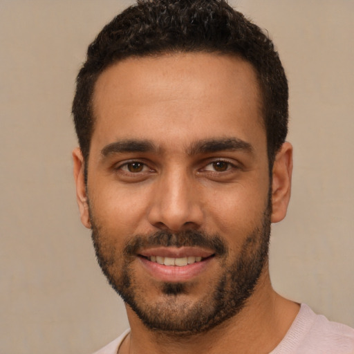 Joyful white young-adult male with short  black hair and brown eyes