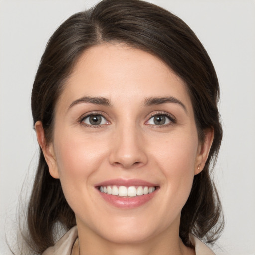 Joyful white young-adult female with medium  brown hair and brown eyes