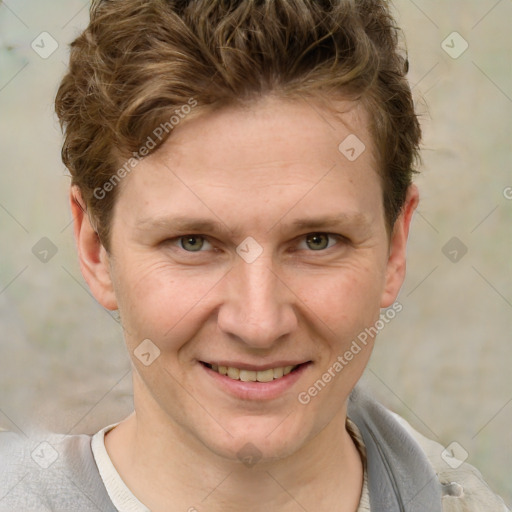 Joyful white adult male with short  brown hair and grey eyes