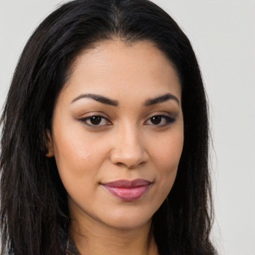 Joyful latino young-adult female with long  brown hair and brown eyes