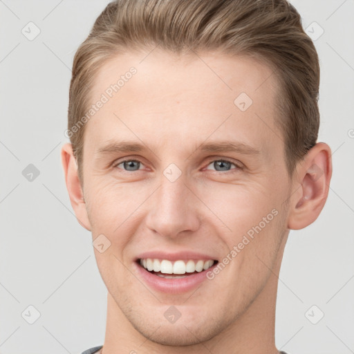 Joyful white young-adult male with short  brown hair and grey eyes