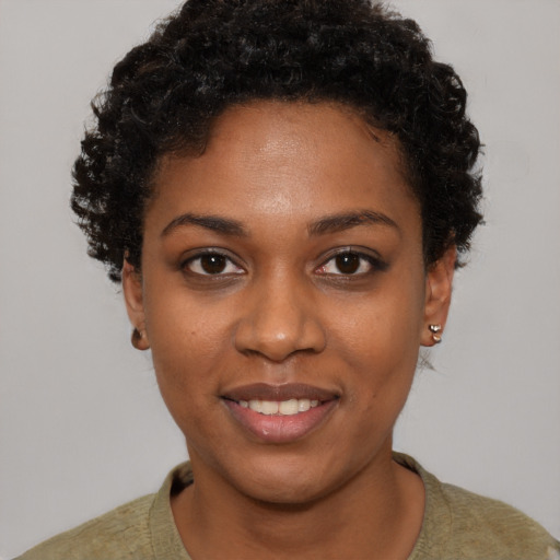Joyful black young-adult female with short  brown hair and brown eyes