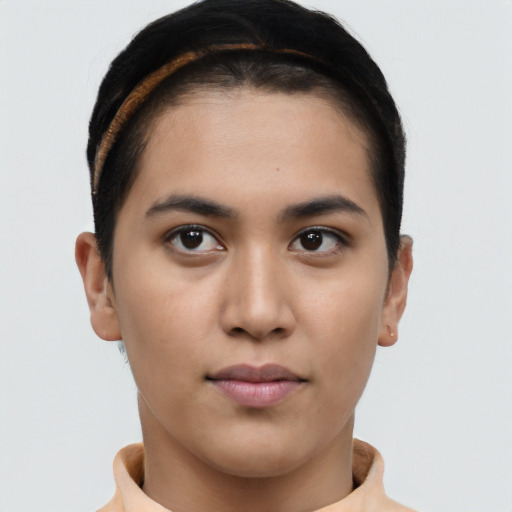 Joyful latino young-adult female with short  brown hair and brown eyes