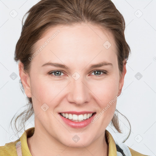 Joyful white young-adult female with medium  brown hair and grey eyes