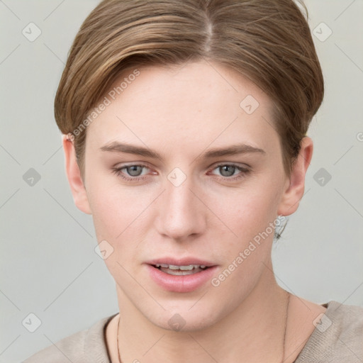 Joyful white young-adult female with short  brown hair and grey eyes