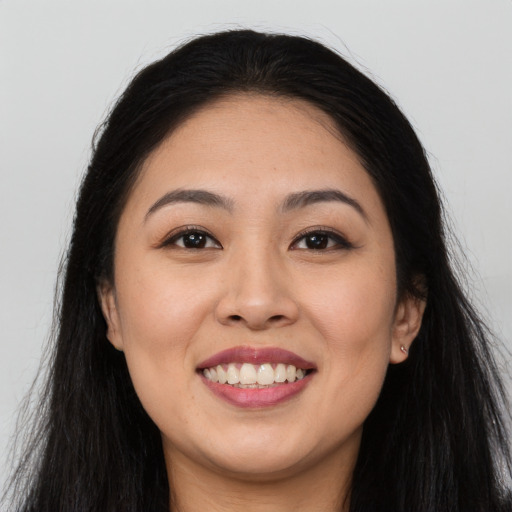Joyful latino young-adult female with long  brown hair and brown eyes