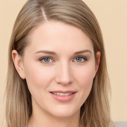 Joyful white young-adult female with long  brown hair and grey eyes