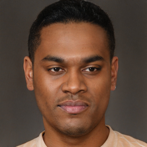 Joyful latino young-adult male with short  brown hair and brown eyes