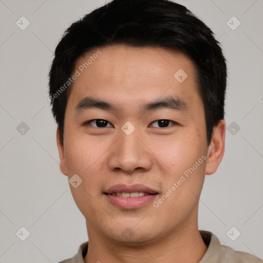 Joyful asian young-adult male with short  black hair and brown eyes