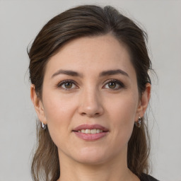 Joyful white young-adult female with medium  brown hair and grey eyes