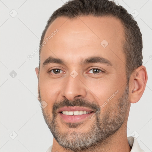 Joyful white adult male with short  brown hair and brown eyes