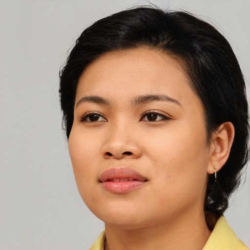 Joyful asian young-adult female with medium  black hair and brown eyes