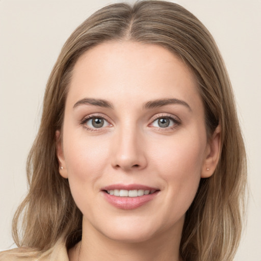 Joyful white young-adult female with medium  brown hair and grey eyes