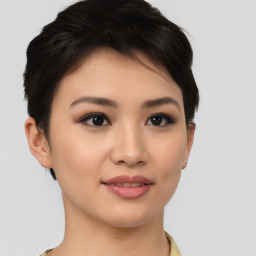 Joyful asian young-adult female with short  brown hair and brown eyes