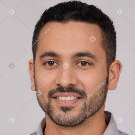 Joyful white young-adult male with short  black hair and brown eyes