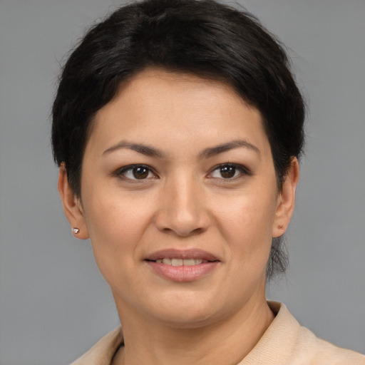 Joyful latino young-adult female with short  brown hair and brown eyes