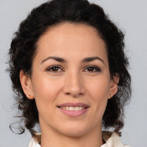 Joyful white adult female with medium  brown hair and brown eyes