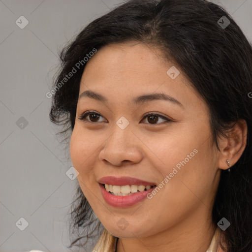 Joyful latino young-adult female with long  brown hair and brown eyes