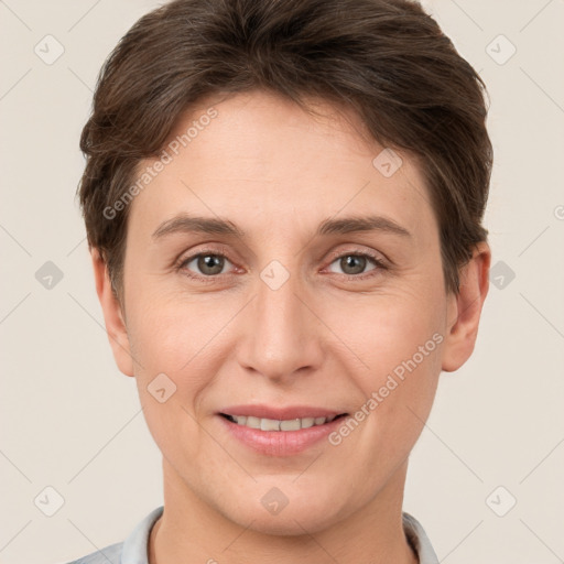 Joyful white young-adult female with short  brown hair and grey eyes