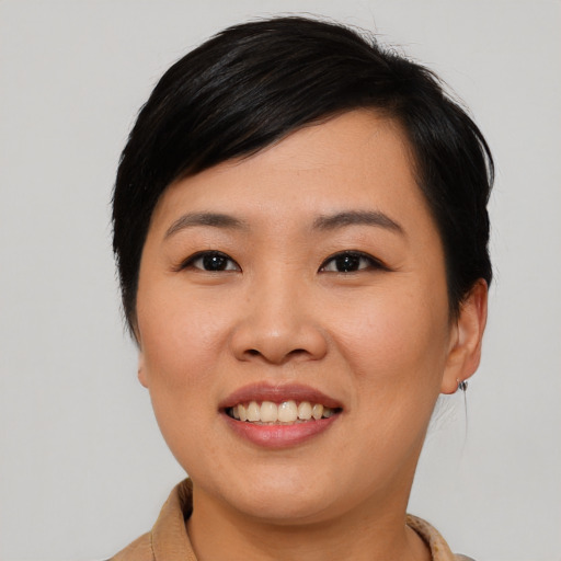 Joyful asian young-adult female with short  black hair and brown eyes