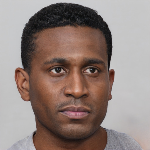 Neutral black young-adult male with short  black hair and brown eyes