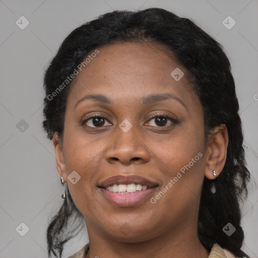 Joyful black adult female with long  brown hair and brown eyes