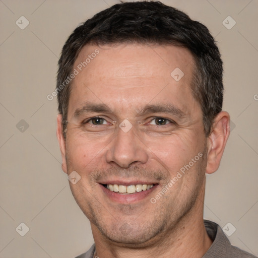 Joyful white adult male with short  brown hair and brown eyes