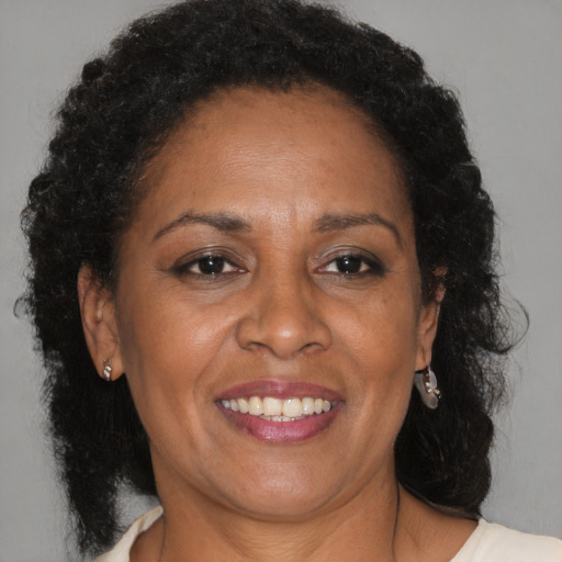 Joyful black adult female with medium  brown hair and brown eyes