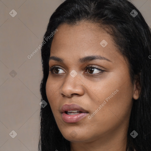 Joyful latino young-adult female with long  black hair and brown eyes