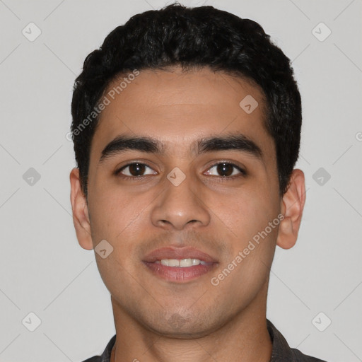 Joyful latino young-adult male with short  black hair and brown eyes