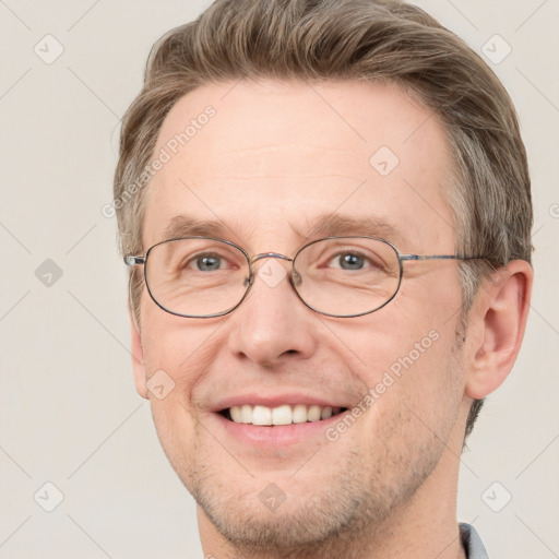 Joyful white adult male with short  brown hair and grey eyes